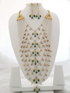 Satlada necklace with pearls, green stones, and gold-polished jadau work by Kisa Hyderabadi Zevar