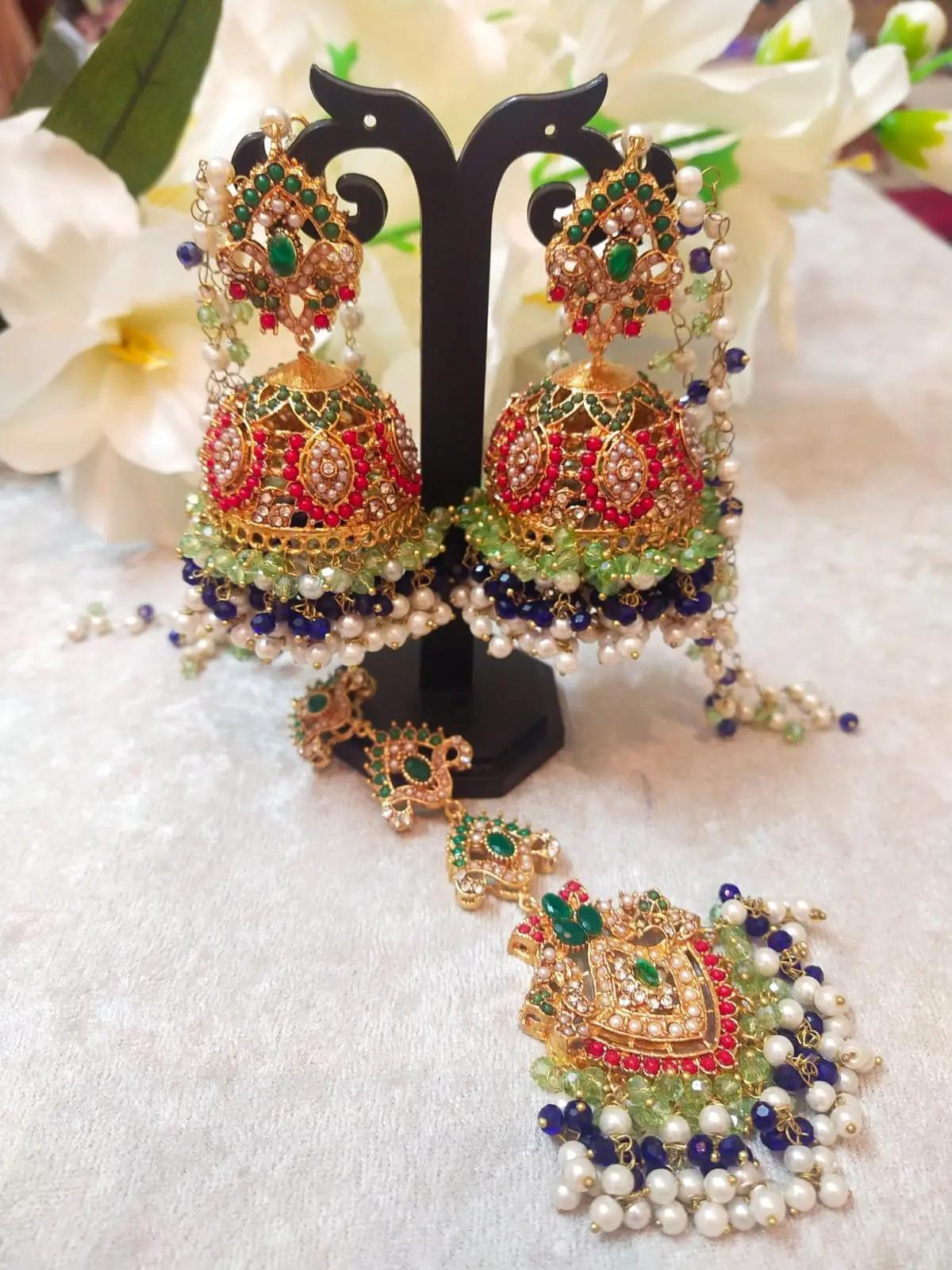 Blue Jhumka with Maang Tikka Set featuring Hyderabadi jadau craftsmanship and semi-precious blue and white stones.