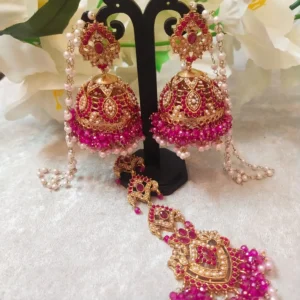 Pink Jhumka with Tikka Set featuring Hyderabadi jadau work and semi-precious pink and white stones.