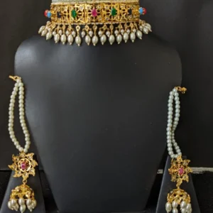Close-up of Hyderabadi jadavi lacha jewellery with meenakari work & red stone droplets