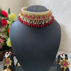 Handcrafted bridal red stone jadavi lacha set necklace on display