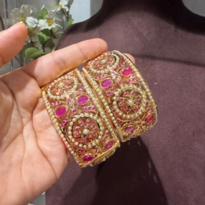 Taheera pink jadau bangles with pink and white stones on a fine gold plated finish