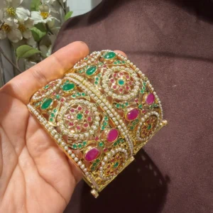 Taheera jadau bangles set with pink, green and white stones on gold plated finish